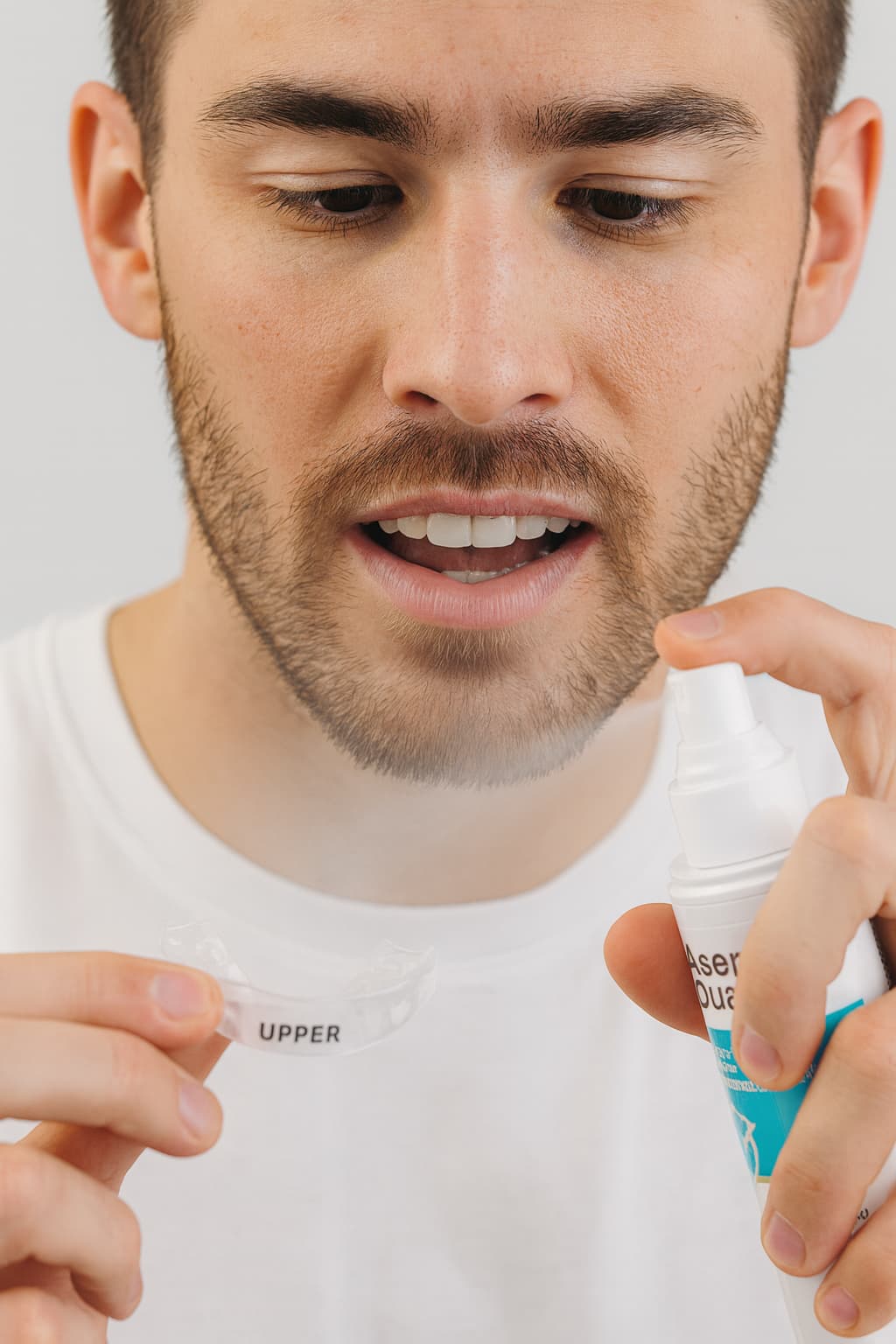 Man using dental appliance spray